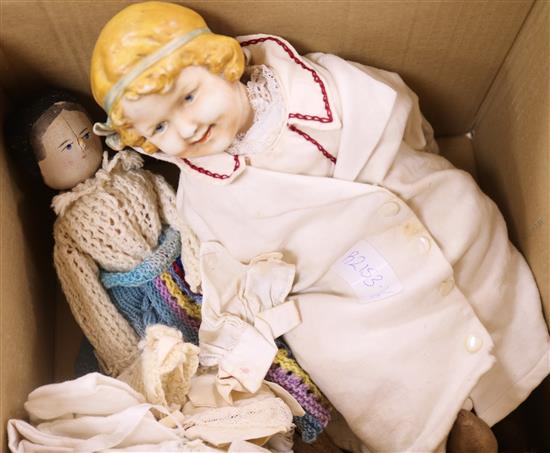 A bisque headed doll and a peg dolls and clothing